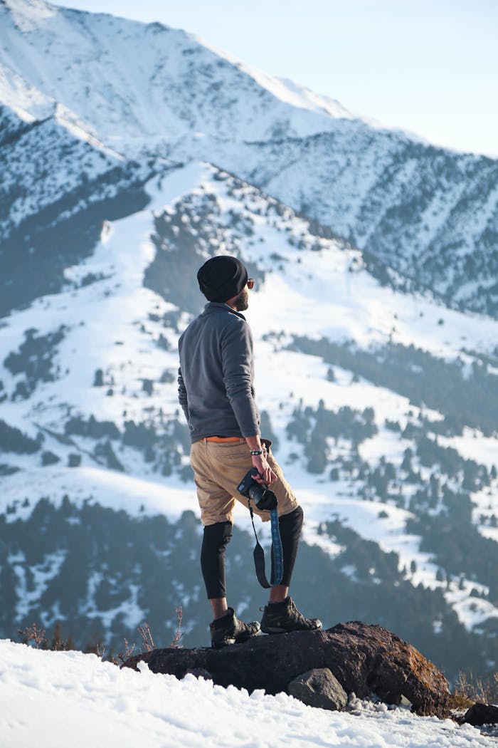 Adventurer explores snowy terrain in Ak-Talaa District, showcasing the beauty of Kyrgyzstans winter landscape.